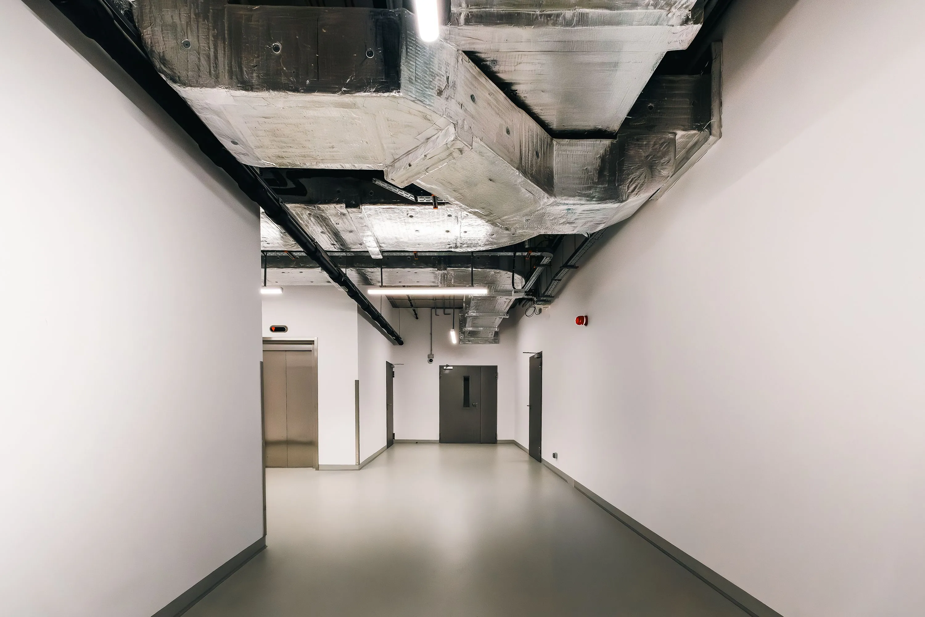 Commercial interior with exposed ceiling services