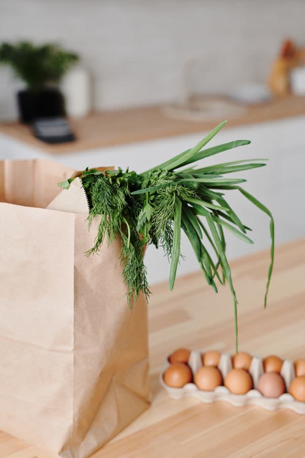 Paper grocery bag and eggs on a kitchen counter