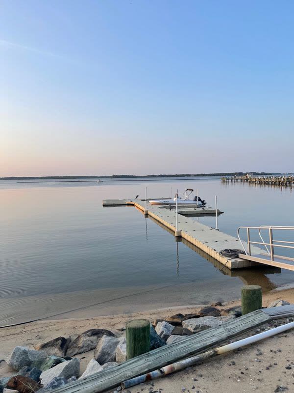 Calm bay water and a boat dock at dusk