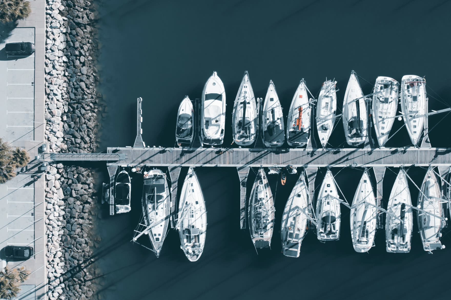 Boats moored along a pier, seen from above