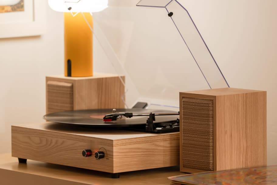 Light oak turntable and a matching oak speaker on a sideboard