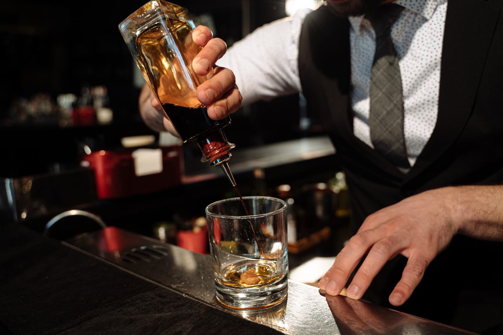 A bartender finishing an old fashioned on the bar at COPPER LANTERN