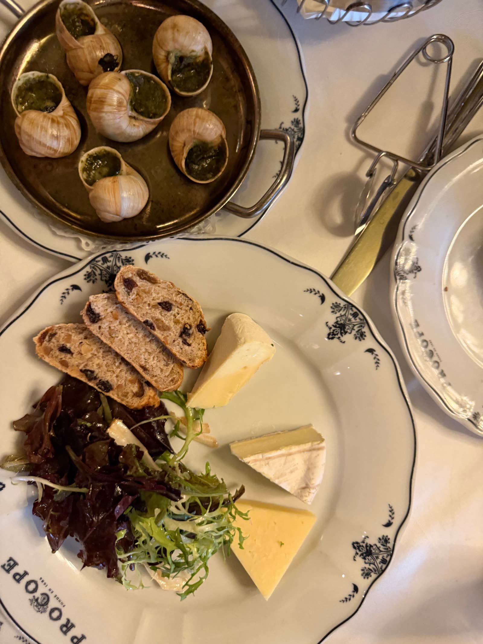 Escargots in herb butter plated on a scalloped dish at COPPER LANTERN
