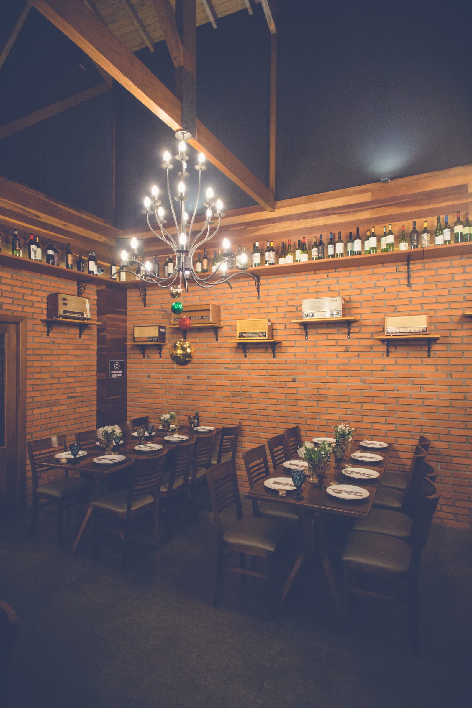 The main dining room at COPPER LANTERN under its chandelier, set for dinner