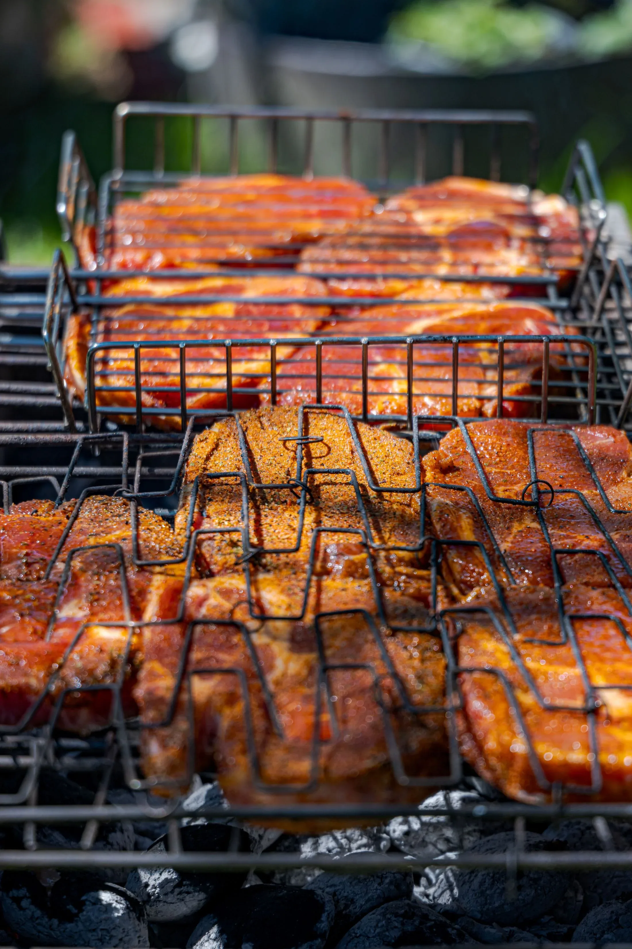 Racks of spare ribs on the pit grate