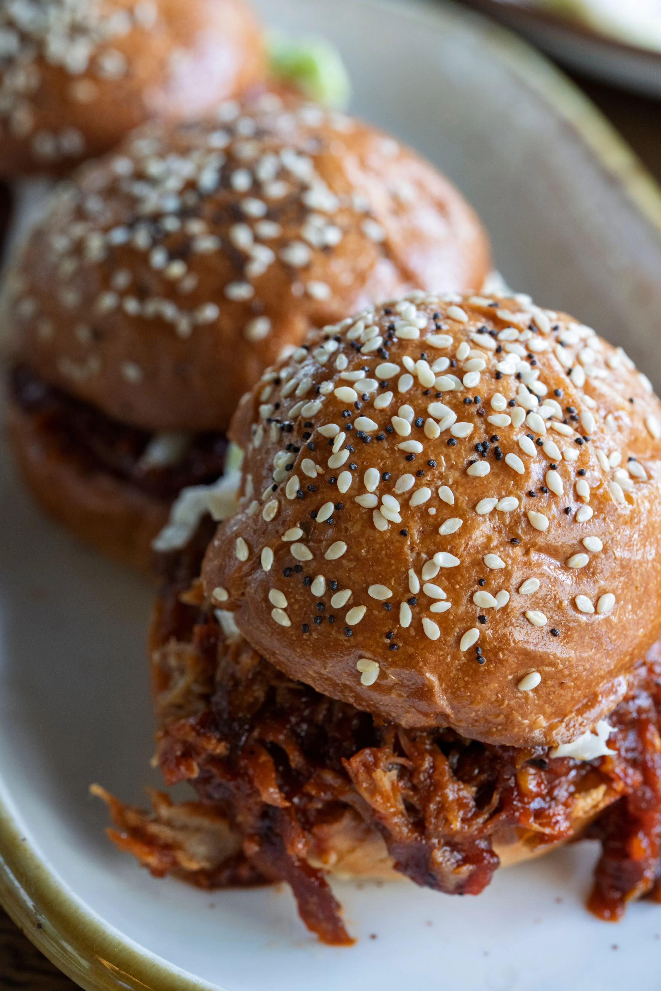 Barbecue sandwiches with pickles on a tray