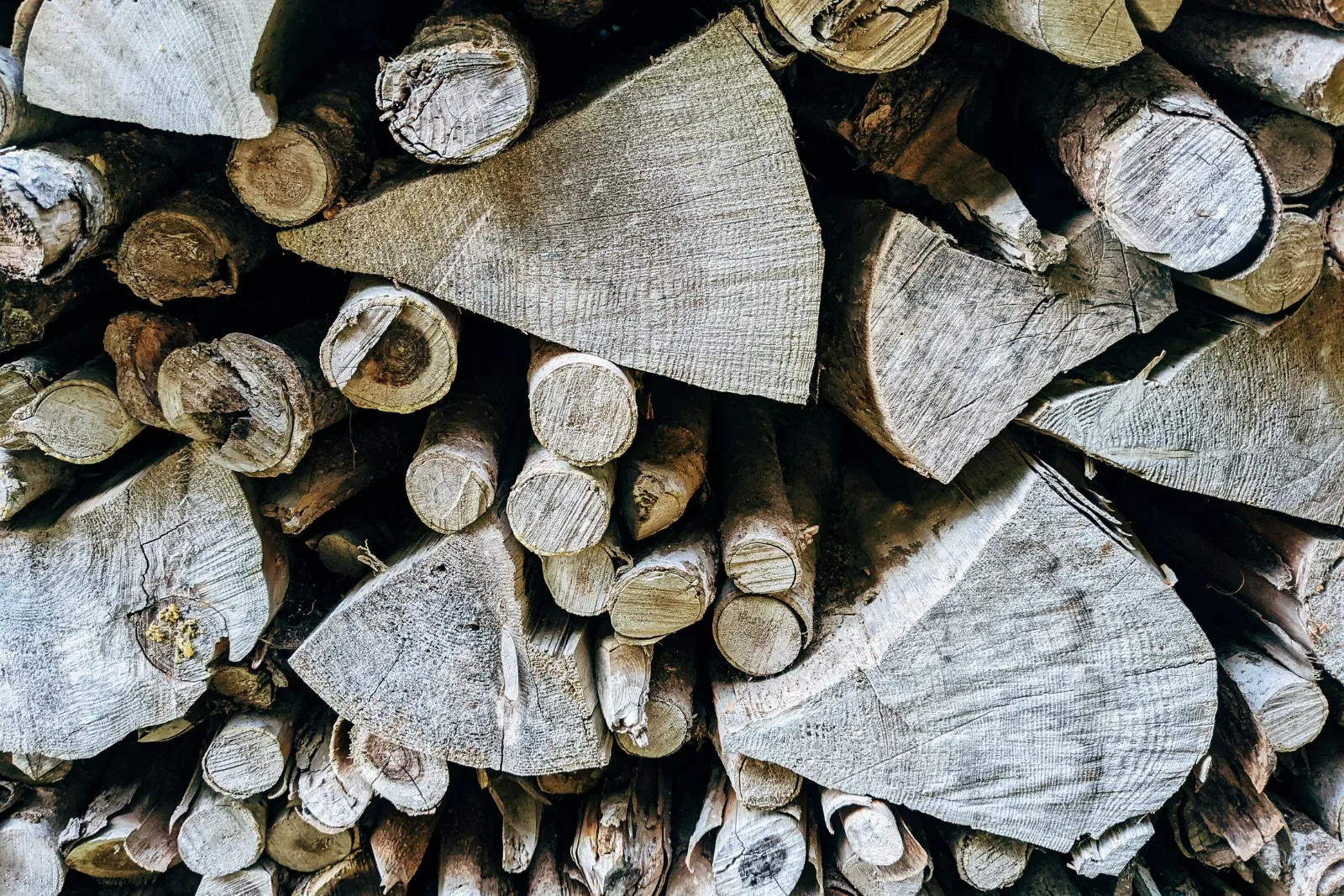 Split oak firewood stacked for the pits