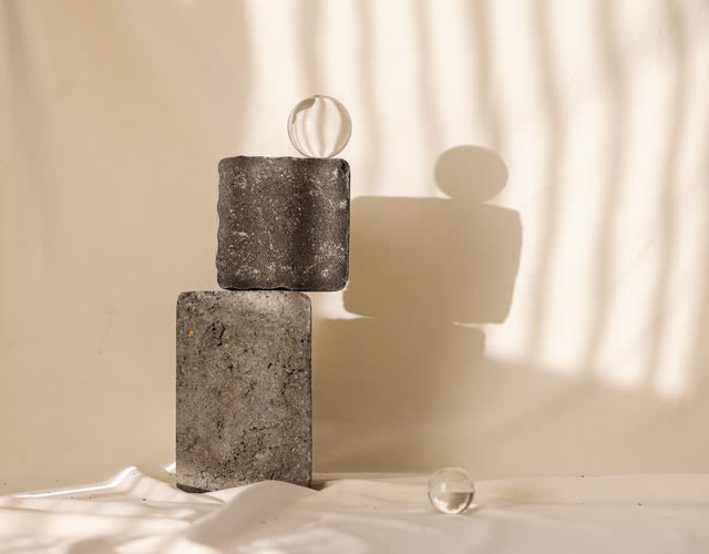 Two stacked stones in soft window light