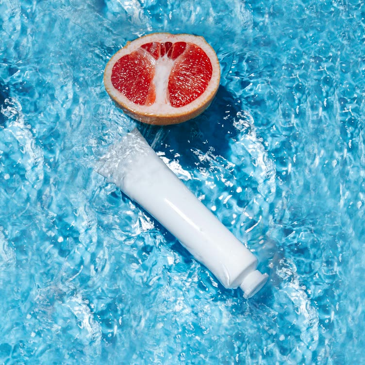 Oat Milk Gel Cleanser tube floating in clear water