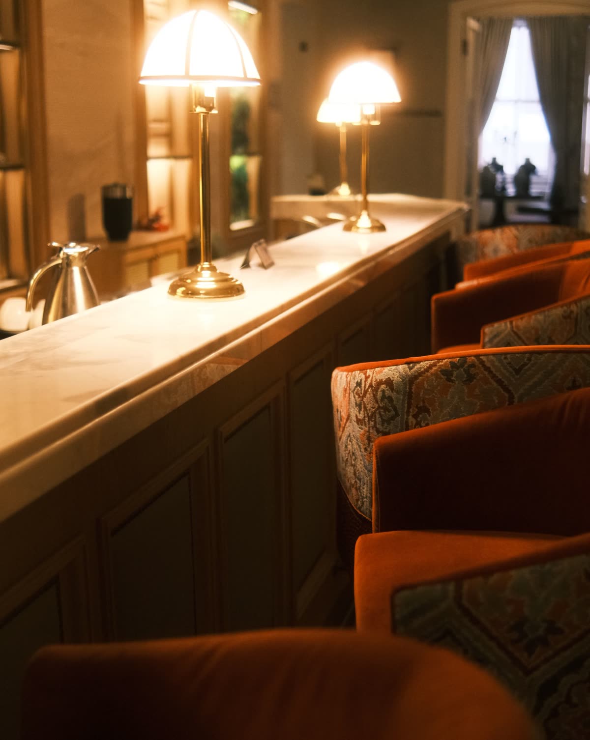 Brass lamps on the marble bar counter