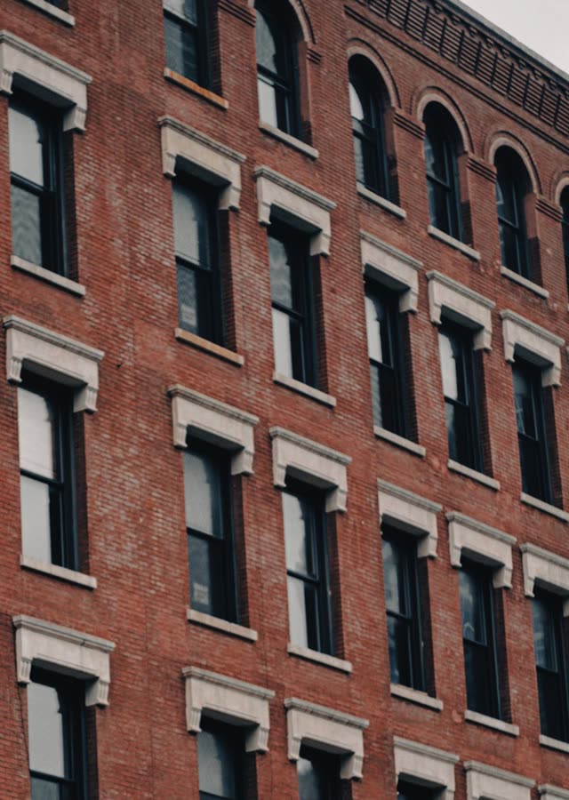 Six-storey red brick facade with stone window lintels