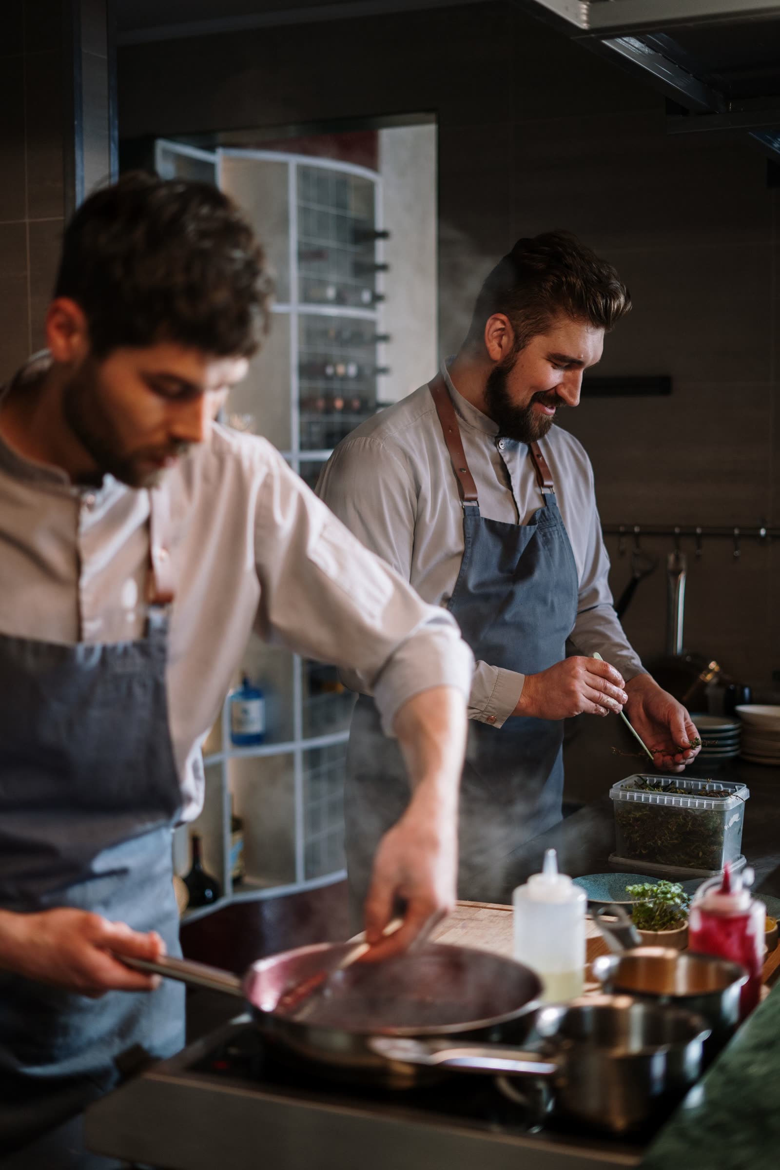 Cooks working the pass in the open HOLLOW FIG kitchen