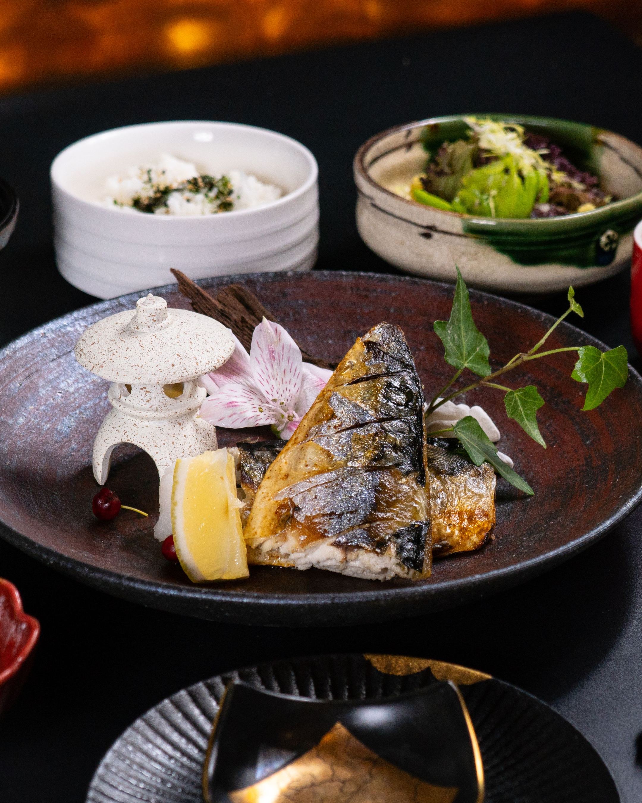 焼き魚を中心に小鉢と椀をならべた膳