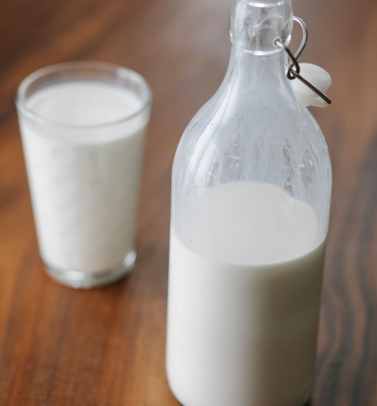 牛乳を注いだグラスと、栓つきのガラス瓶
