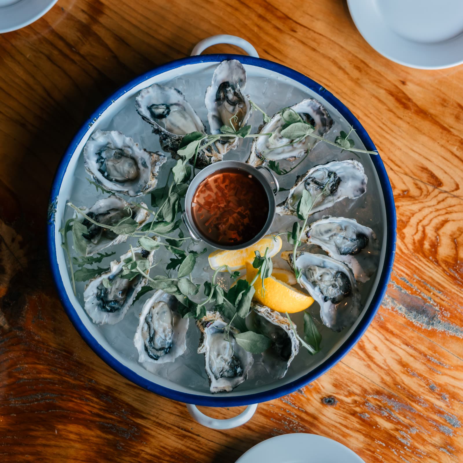 A dozen oysters on ice with lemon and mignonette