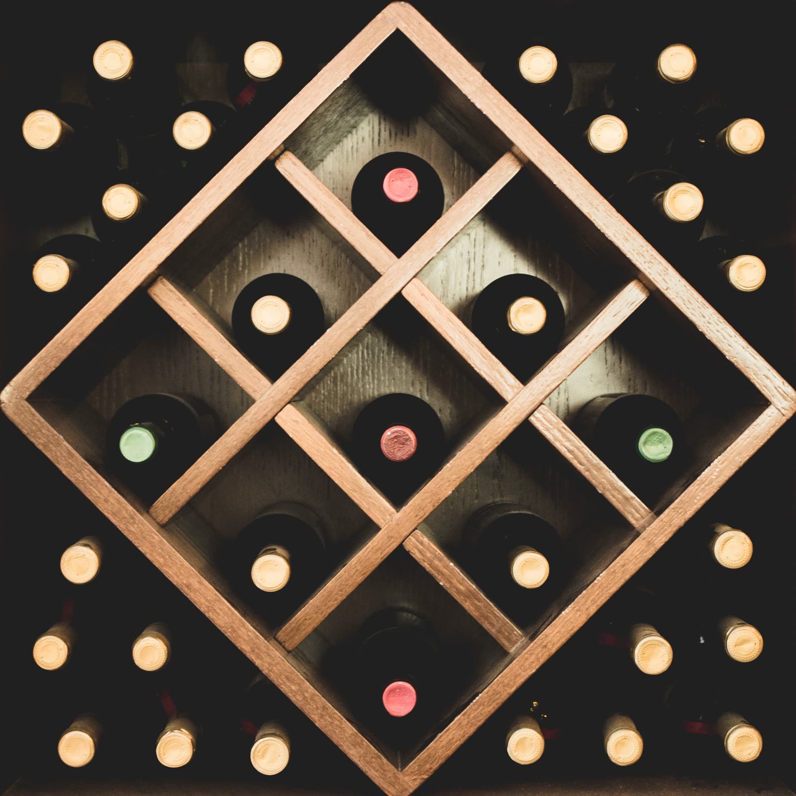Wine bottles resting in a diamond-shaped rack