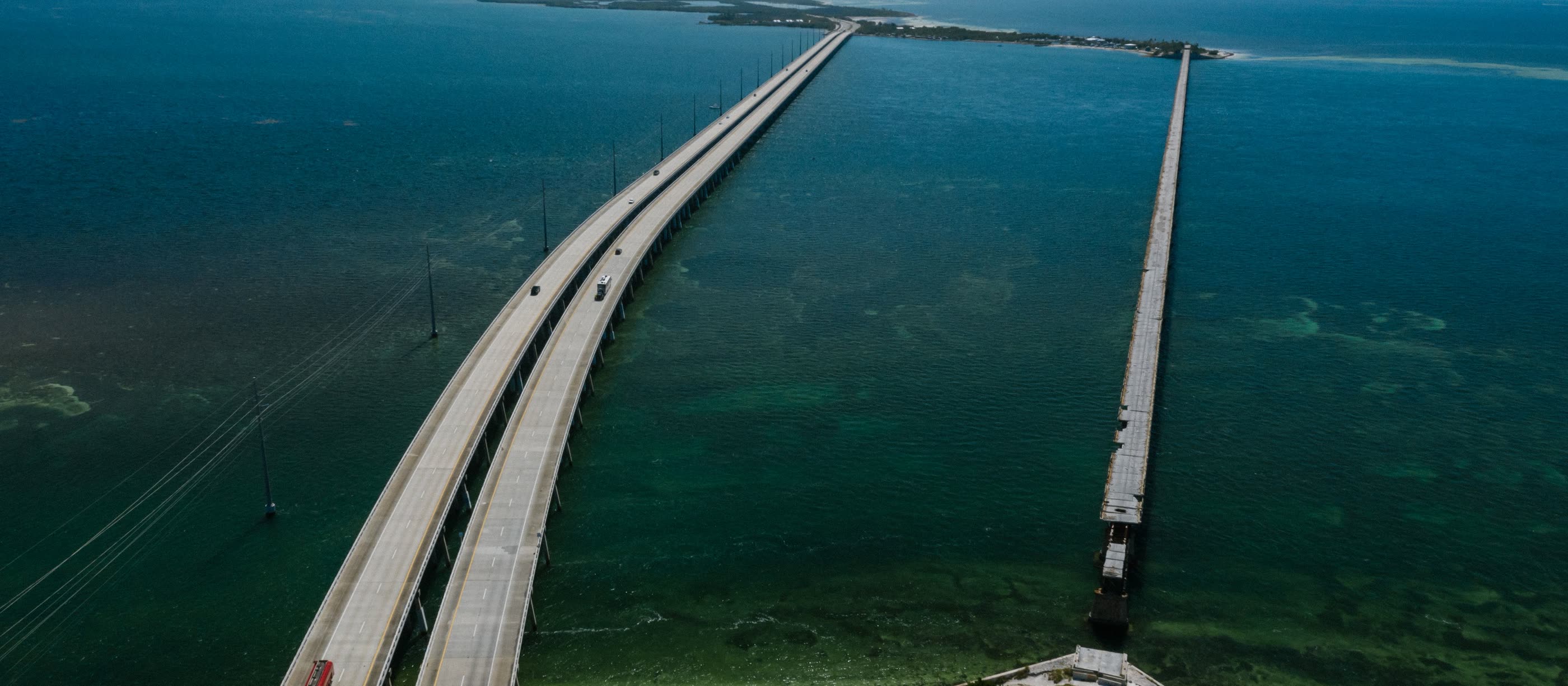 The Overseas Highway crossing open water between two keys, seen from above