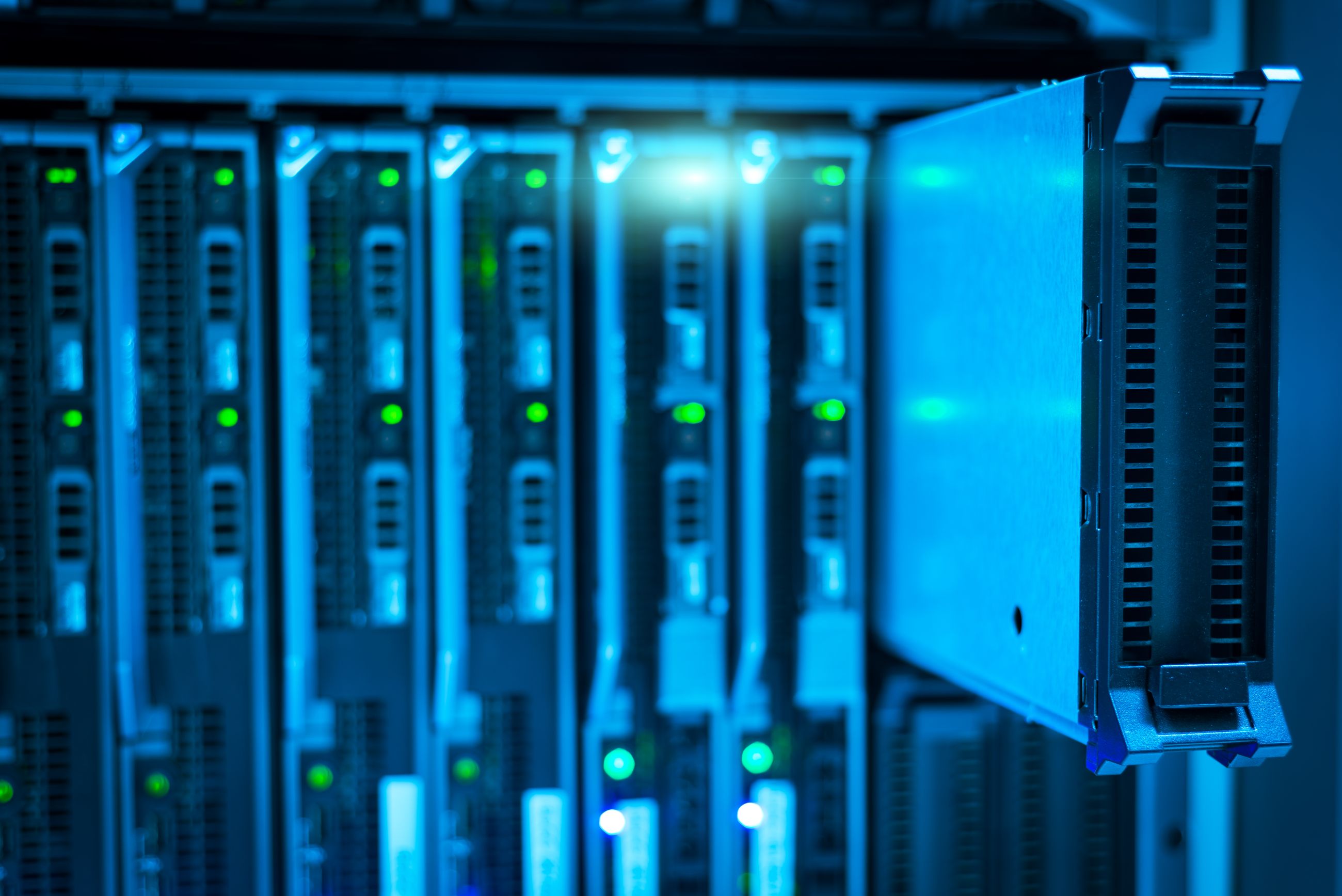 Server blades lit blue in a rack