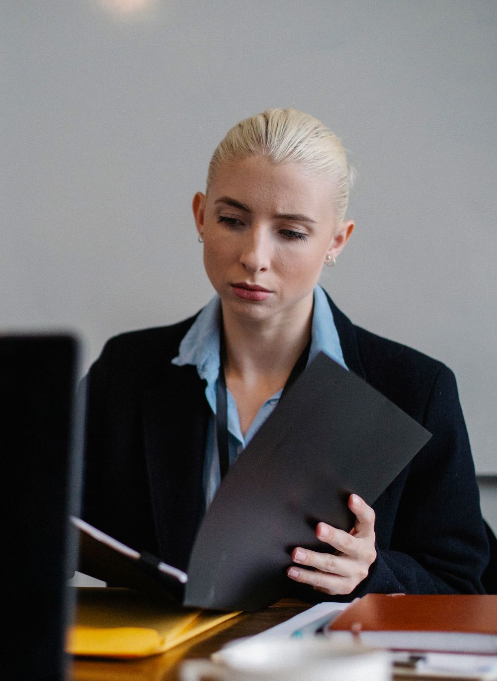 An analyst reading a folder of printed documents
