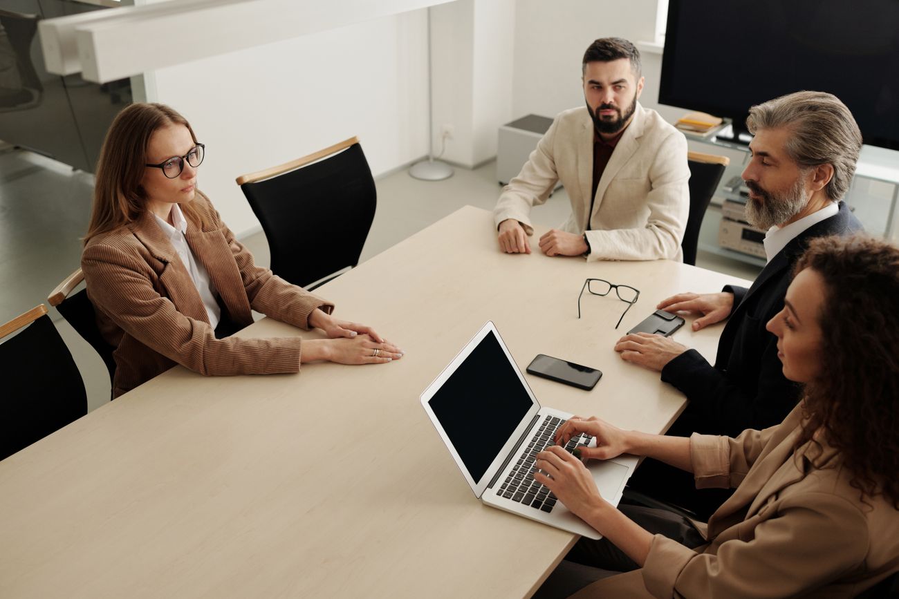 Four colleagues around a meeting table