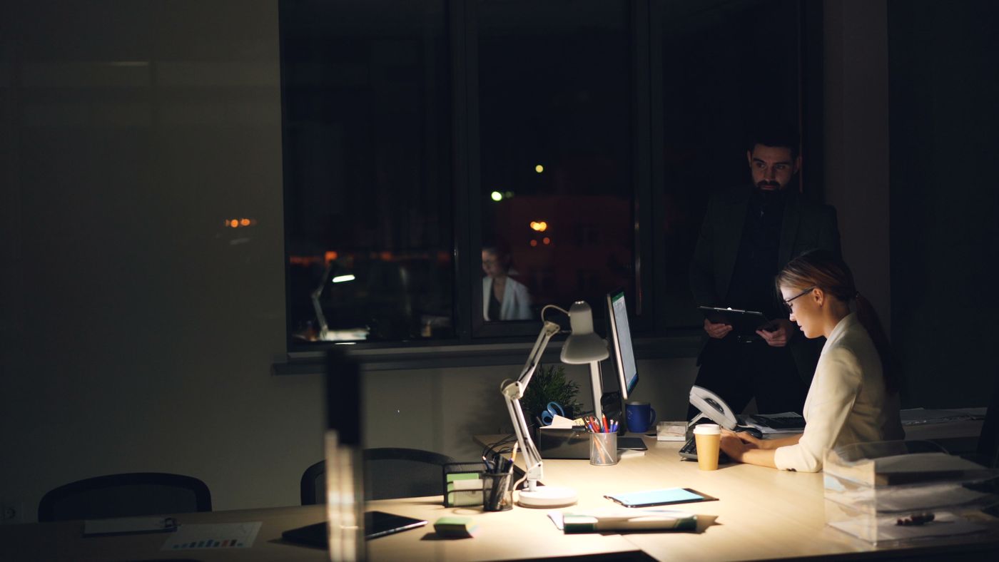 Two people working late in a dark office