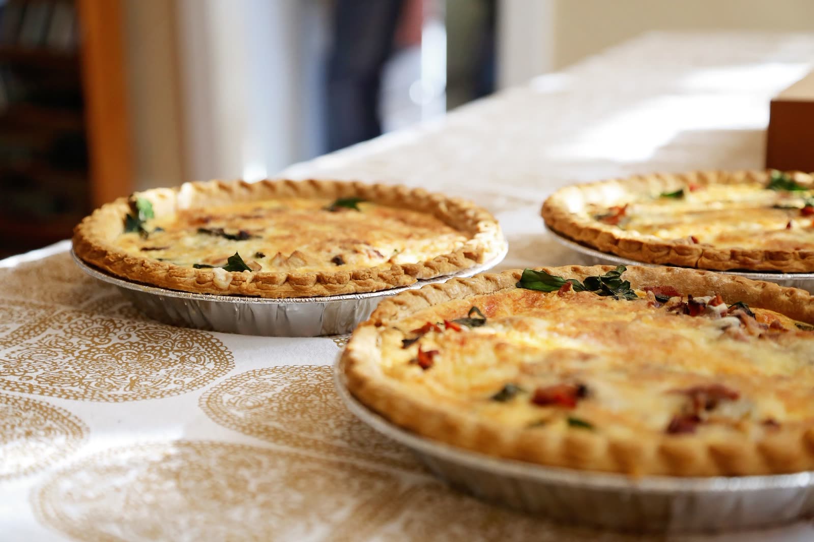 A whole salted cheese tart on a stand at the centre of the room