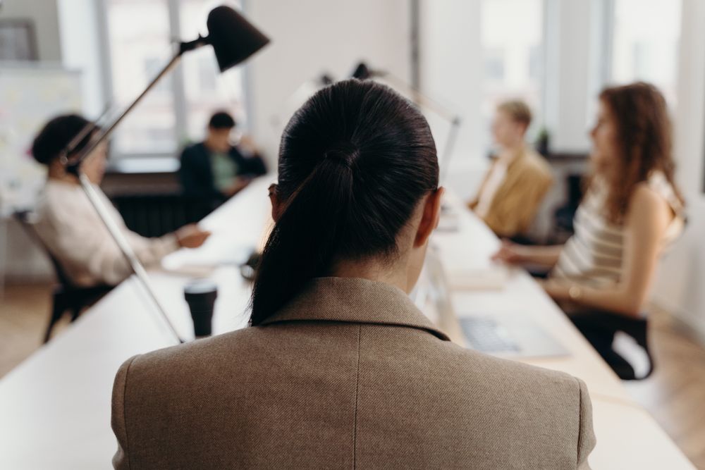 A manager in a meeting, seen from behind