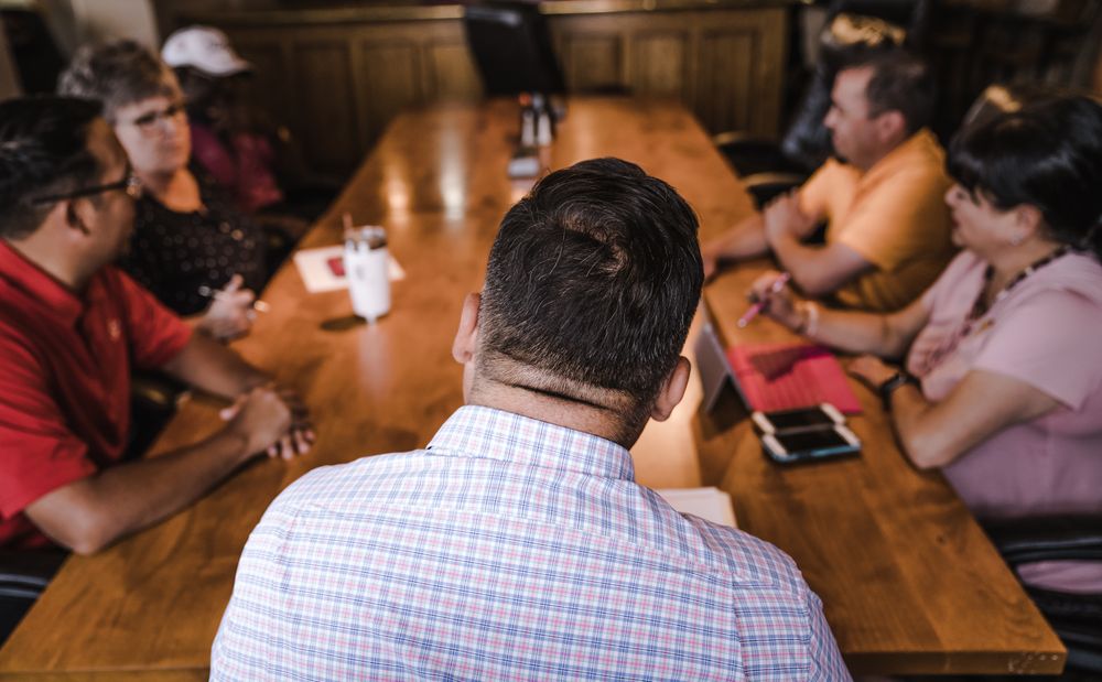 A team around a long wooden table