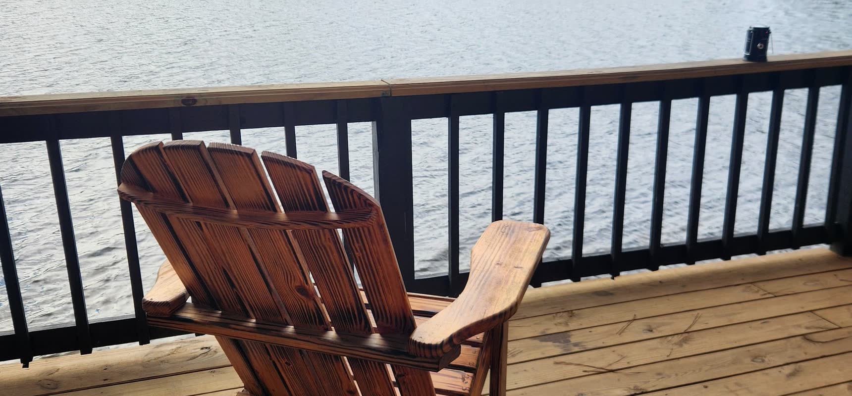 Midweek on the Water — a wooden chair on a deck over the lake