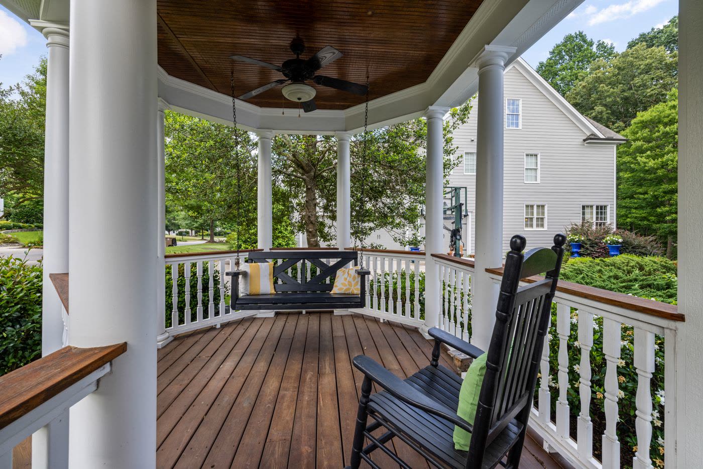 Covered porch with rocking chairs and a porch swing